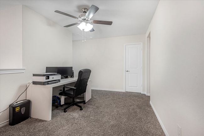 Office space featuring carpet floors, ceiling fan, and baseboards | Image 29