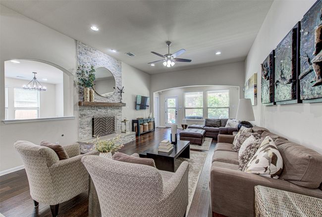 Relax in the Comfort of the Spacious Living Room, Accentuated by a Stunning Stone Fireplace, Creating a Cozy Ambiance for Gatherings | Image 15