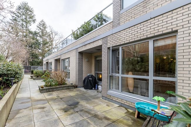 View of patio with fence and area for grilling | Image 14