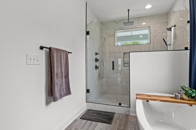 Full bathroom featuring a freestanding bath, a stall shower, wood finished floors, and recessed lighting | Image 11