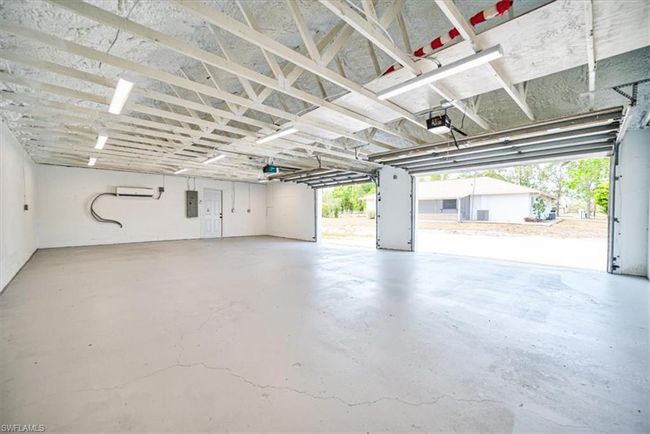 Garage with a garage door opener and electric panel | Image 42