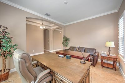 Tiled home office with a chandelier and ornamental molding | Image 3