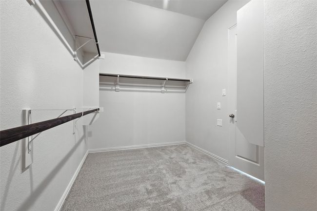 Walk in closet with carpet floors and vaulted ceiling | Image 25