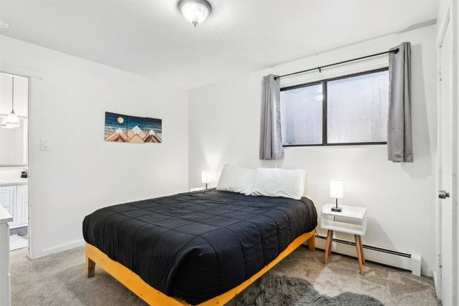 Carpeted bedroom with a baseboard radiator and baseboards | Image 20