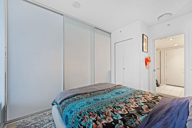 Bedroom featuring a closet and light tile patterned flooring | Image 13