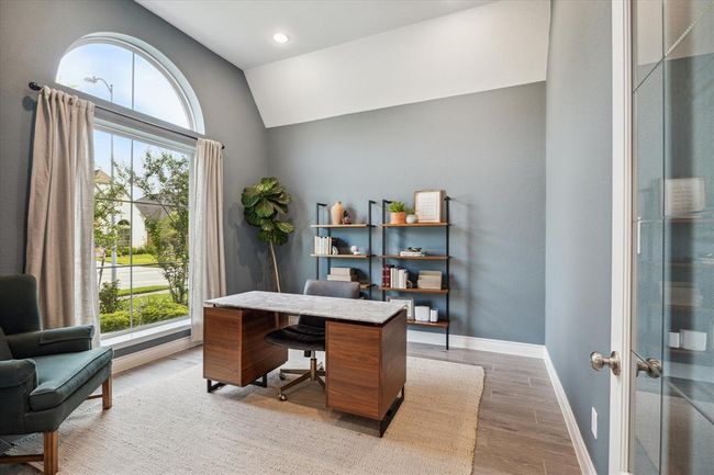 The library exudes refined sophistication, with arched windows, a coffered ceiling, and elegant French doors that lend the space a distinguished yet welcoming ambiance, making it the perfect setting for focused reading or quiet work. | Image 21