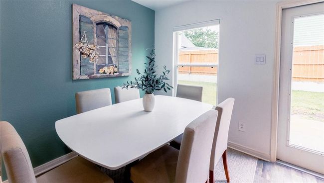 Dining room with convenient access and a view to the backyard. | Image 12