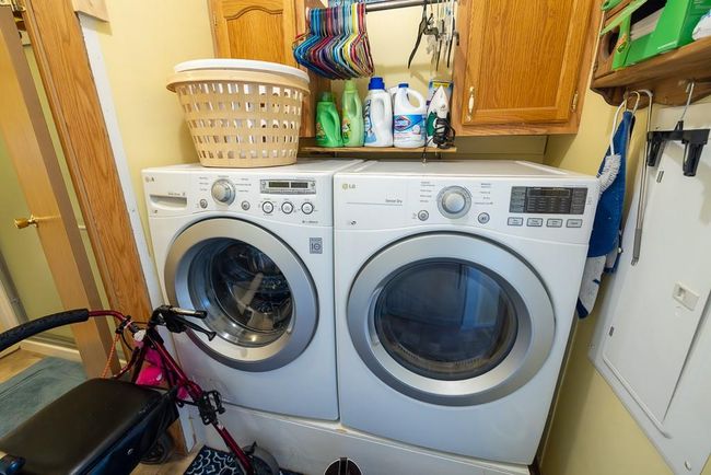 Laundry room featuring independent washer and dryer and cabinet space | Image 62