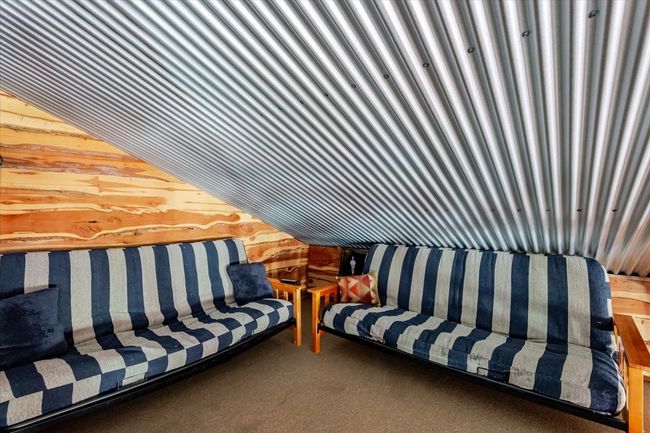 Carpeted living area featuring wood walls | Image 14