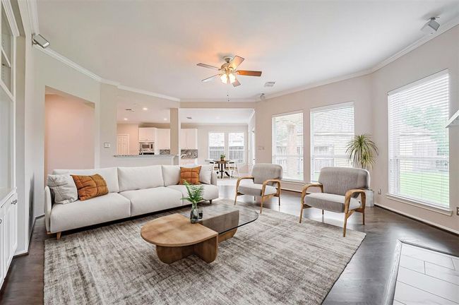 Living room is full of light that gives you the peaceful view of the backyard, including the coziness of the fireplace.Virtual staging | Image 15