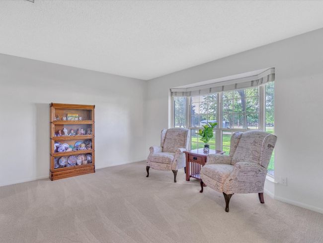 Sitting room with carpet floors and baseboards | Image 8