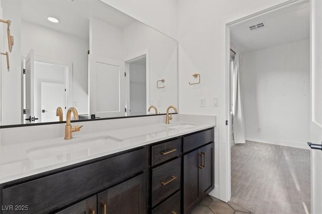 Full bathroom featuring double vanity, visible vents, tile patterned flooring, and a sink | Image 44