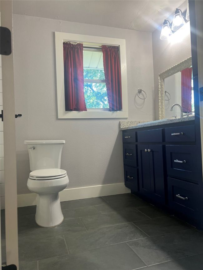 Bathroom featuring vanity and toilet | Image 11
