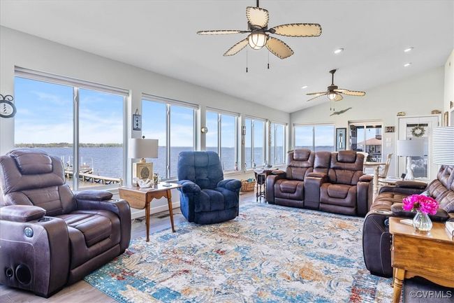 Living area with recessed lighting, a wealth of natural light, a ceiling fan, and vaulted ceiling. River views that go on for days and days! This is looking towards Jamestown Island | Image 15