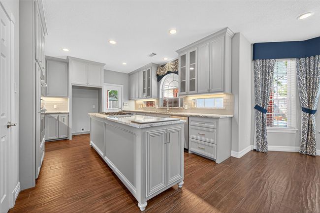 Kitchen with gas cooktop in Island and hidden Pop-Up TV, can you find it? | Image 17