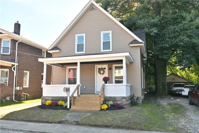 Bungalow-style home featuring a porch and a carport | Image 1