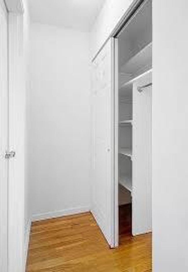 Community laundry with washer and dryer and tile patterned floors | Image 4