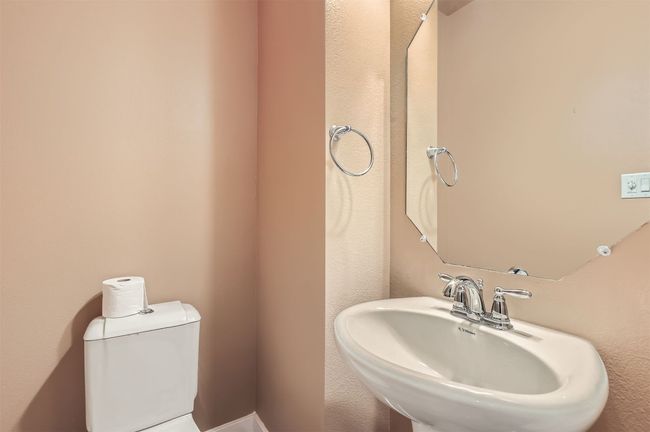 Bathroom featuring a sink and toilet | Image 11