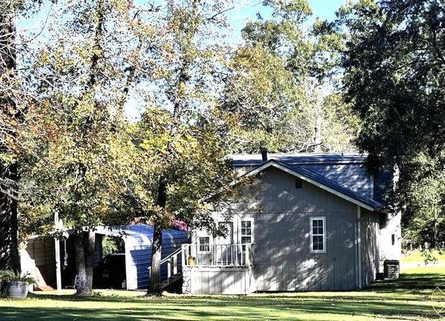 View of the back of the home and carport. | Image 9