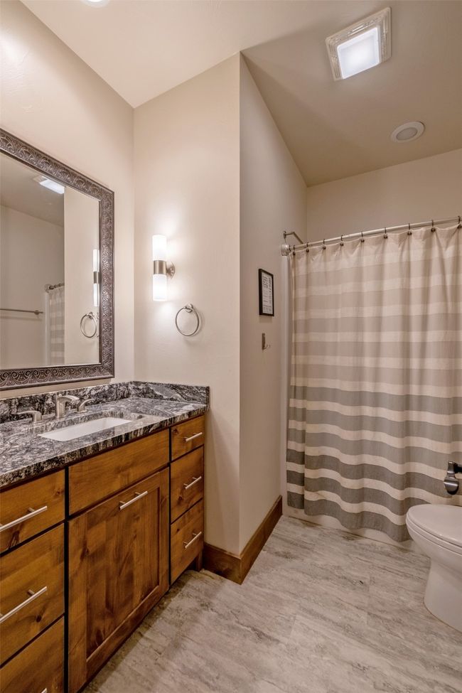 Bathroom with vanity, toilet, baseboards, and a shower with curtain | Image 24