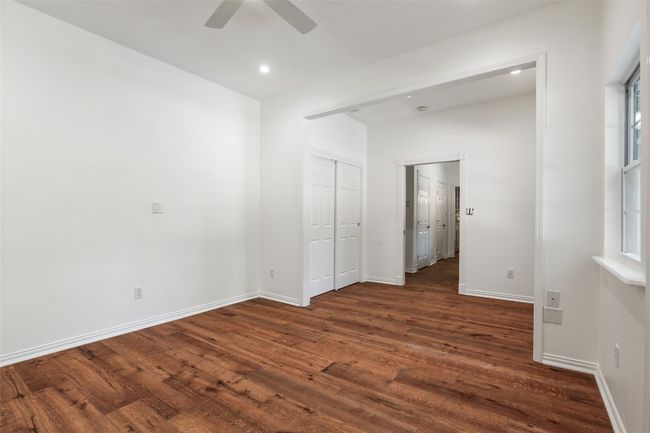 Unfurnished bedroom featuring dark wood-style floors, recessed lighting, a ceiling fan, and a closet | Image 12
