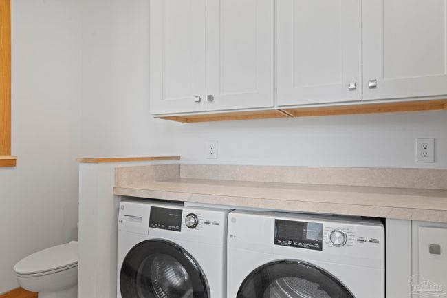private water closet with laundry for convenience | Image 22