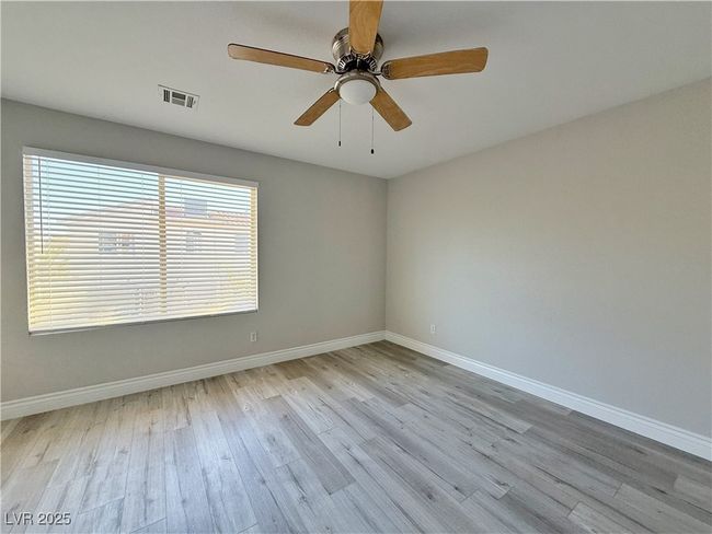 Unfurnished room featuring visible vents, ceiling fan, baseboards, and wood finished floors | Image 23
