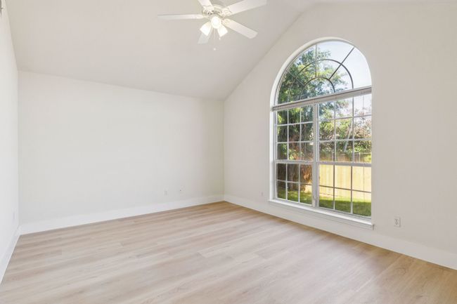 Bonus room featuring healthy amount of natural light, light wood-style floors, vaulted ceiling, and ceiling fan | Image 21