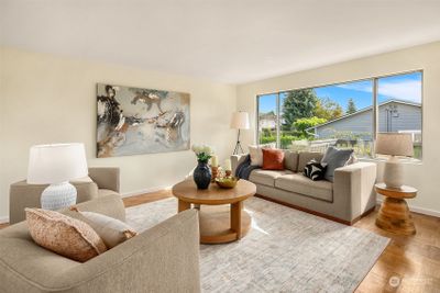 The south facing spacious living room with views of the neighborhood and backyard. | Image 3