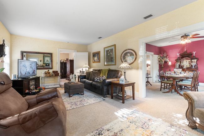 Living area featuring light carpet and ceiling fan | Image 8