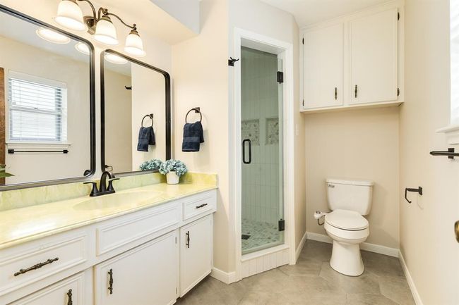 Primary bath offers a vanity and walk-in shower. | Image 22