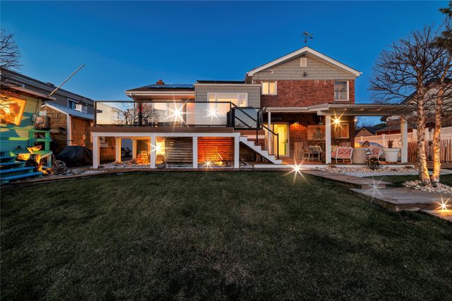 Rear view of property featuring fence, solar panels, a patio area, and a lawn | Image 27