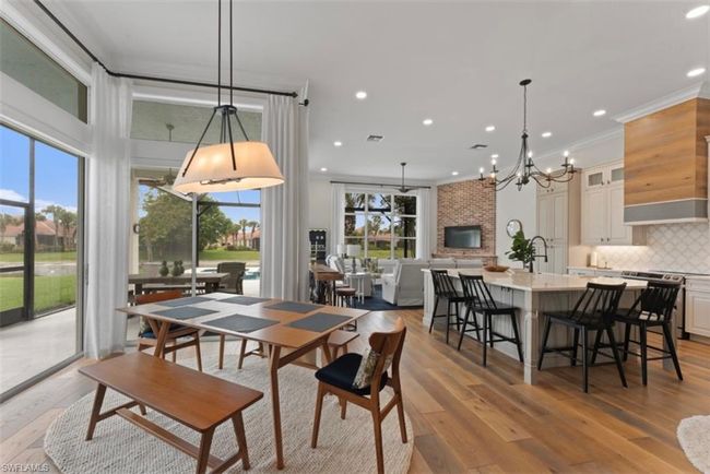 Dining area with a chandelier, light wood-style flooring, recessed lighting, and ornamental molding | Image 9