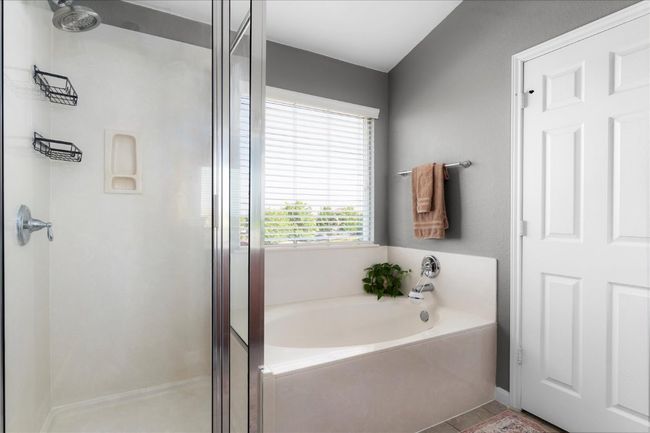 Bathroom featuring a stall shower and a bath | Image 17