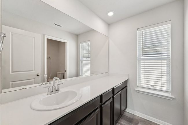 Bathroom with vanity, toilet, baseboards, and wood finished floors | Image 16