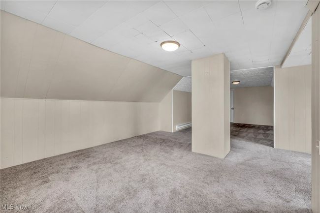 Bonus room with wood walls, carpet, and a baseboard radiator | Image 40