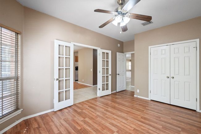 Spare room that can be an office, study or bedroom with a ceiling fan, french doors, and closet | Image 7