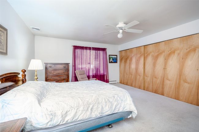 Carpeted bedroom featuring ceiling fan | Image 23
