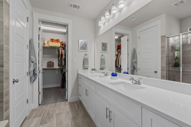 Bathroom with double vanity, a walk-in closet, a large walk-in shower. | Image 17