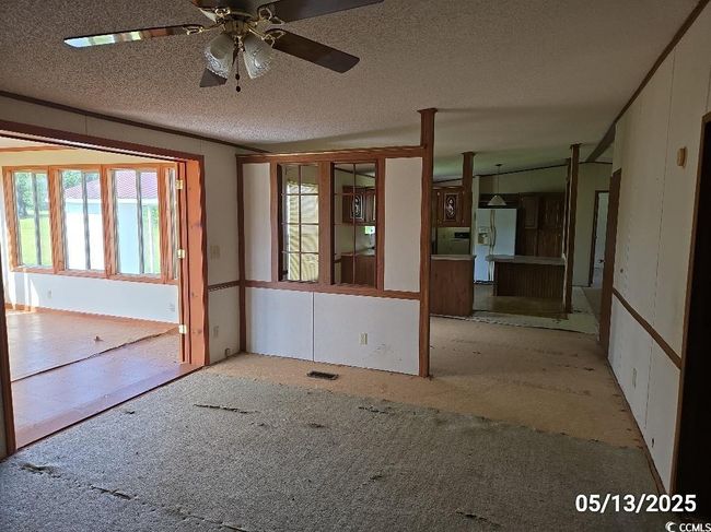 Empty room featuring ceiling fan and a textured ceiling | Image 35