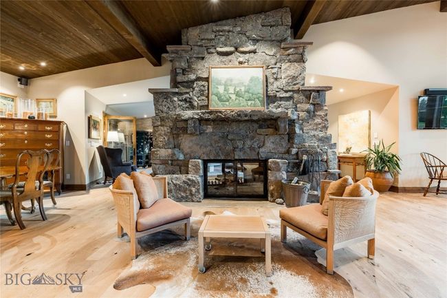 The wood burning fireplace crackles with warmth on cold days. Double sided for maxim enjoyment from multiple spaces. | Image 21