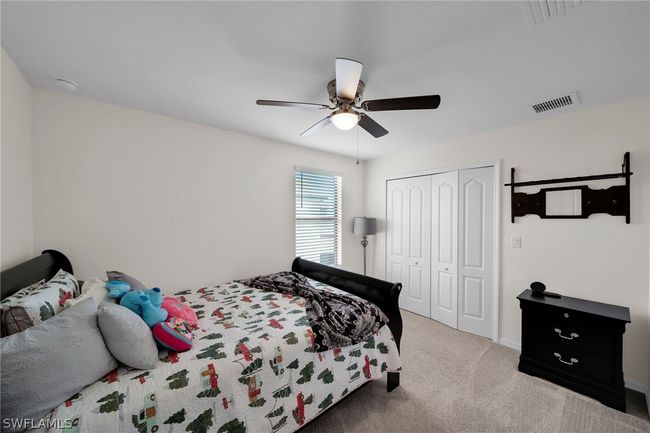 Bedroom with carpet flooring, a closet, and ceiling fan | Image 34
