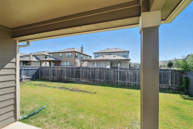 Fenced backyard with a residential view and a patio area | Image 27
