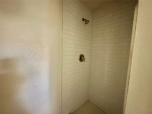 Bathroom view of a tile shower | Image 17