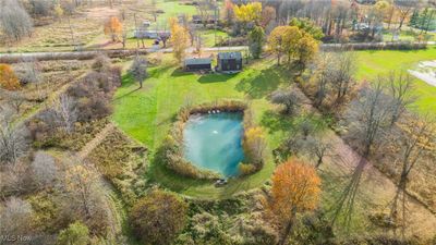 Birds eye view of property with a stocked pond. | Image 3