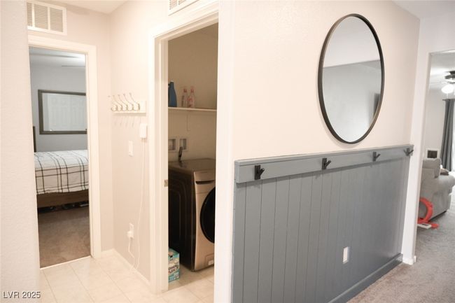Hall with washer / dryer, carpet floors, and visible vents | Image 5