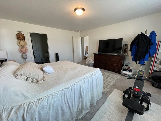 The primary bedroom is located off the loft & has plenty of space for the King sized bed. | Image 21