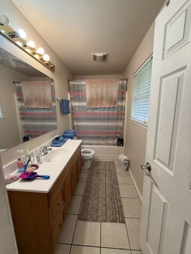 Full bath with a textured ceiling, vanity, visible vents, toilet, and tile patterned floors | Image 7
