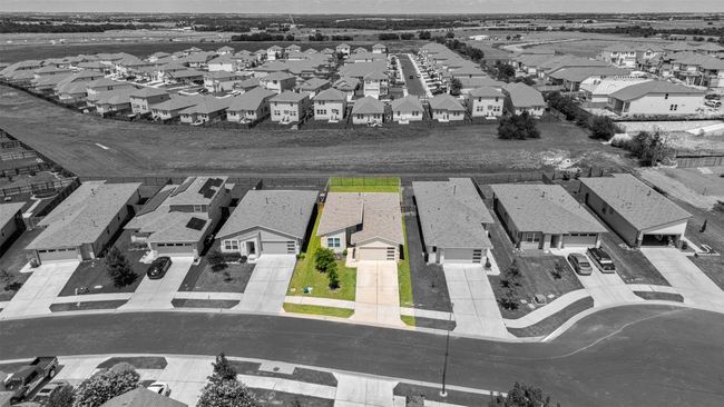 An aerial view of the property with a highlight, emphasizing its location and footprint within the surrounding neighborhood. | Image 27