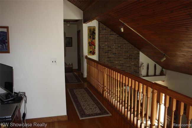 Loft area with lookout over the living room. | Image 43